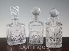 Three cut and moulded glass decanters and stoppers, largest 26cm
