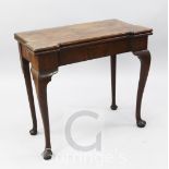 A George III mahogany folding card table, the green baize lined top with decanter stands, raised