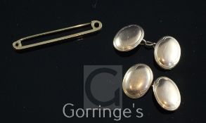 A cased pair of 9ct gold oval cufflinks and a 9ct gold tie pin, gross weight 9 grams.
