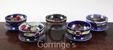 Five Moorcroft pottery sundae dishes, 1930's, in pansy and pomegranate pattern, slight damage,