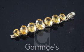 A 14ct gold and citrine bracelet, set with seven graduated oval cut citrines, gross weight 20