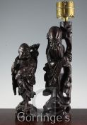 Two Chinese carved rootwood figures, one fitted as a candle lamp, 14in and 11in.