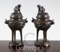 A pair of 19th century Chinese bronze censers, with kylin lid finials, the sides with dragons in