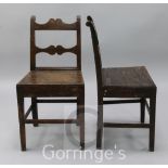 A pair of early 19th century oak wood seat dining chairs, with shaped spars and crest rails