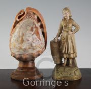 An Ernst Wahliss porcelain figural spill holder, and a cameo carved conch shell mounted as a lamp,