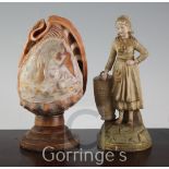 An Ernst Wahliss porcelain figural spill holder, and a cameo carved conch shell mounted as a lamp,