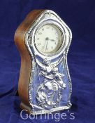 An Edwardian silver mounted wooden mantel timepiece, of waisted form with domed top and Arabic dial,