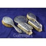 A matched George V five piece silver dressing table set with engraved decoration, various dates &