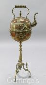 A large North African copper on brass kettle combined brazier, raised on a tripod stand, height