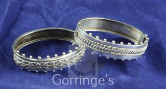 Two similar late Victorian silver hinged bracelets, with ropetwist and beaded decoration, both by