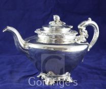 A late Victorian silver plated teapot, of inverted pear form, with scroll feet and melon finial.