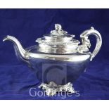 A late Victorian silver plated teapot, of inverted pear form, with scroll feet and melon finial.