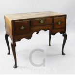 An early 18th century oak lowboy, fitted three small drawers, raised on cabriole legs, width 3ft