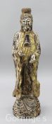 A Chinese carved standing figure of Kwan Yin, polychrome painted and parcel gilt, standing with