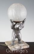 An Art Deco style spelter figural "bear" lamp, with glass globe shade and marble base, 35.5cm