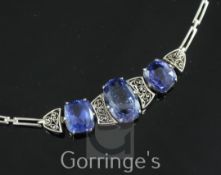 An early 20th century white metal and three stone sapphire bracelet, set with central oval cut