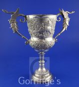 An early 20th century Indian silver presentation trophy cup, with two winged serpent scroll handles,