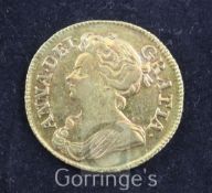 A Queen Anne gold guinea, 1713, VF or better, toned