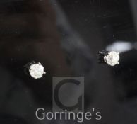 A pair of 18ct white gold and solitaire diamond ear studs, the old mine cut stones having an