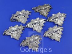 A matched set of seven Victorian silver leaf shaped wine labels, Port, Sherry & Claret, Reily &