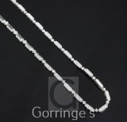 An 18ct white gold and diamond necklace, each oval link set with three round cut diamonds and