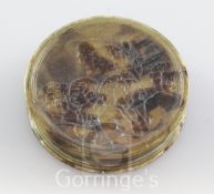 An 18th century blond tortoiseshell circular snuff box, embossed with a satirical scene relating
