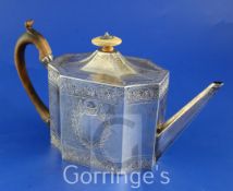 A George III bright cut engraved silver teapot, of rectangular form with inswept corners,