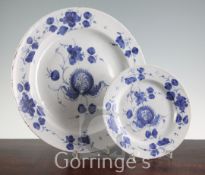 A Glasgow delft ware charger and a similar plate, late 18th century, each painted in blue with a