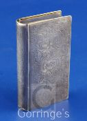 A mid 19th century continental silver double lidded snuff box, modelled as a book, with engraved