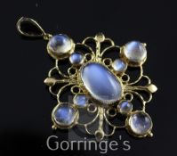 An early to mid 20th century 15ct and moonstone cruciform pendant, set with eight cabochon