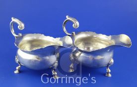 A pair of George II silver sauceboats, with cut rims, engraved armorial and flying scroll handles,