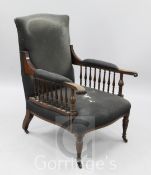 A late Victorian Liberty / Morris style mahogany armchair, with distressed upholstery and spindle