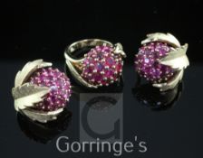 A modern 18ct gold and ruby cluster dress ring and a similar pair of gold ear clips, of domed