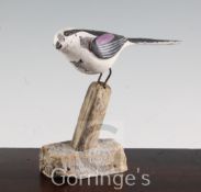 § Guy Taplin (1939-)painted wood,Long Tailed Tit perched on a stump,signed and dated 2000,height