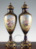 A pair of Sevres style gilt metal mounted urns, first half 20th century, each painted with