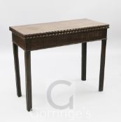 A George III mahogany tea table, with ribbon carved rectangular folding top and fluted frieze, on