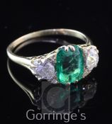 A Victorian style 18ct gold, three stone emerald and diamond ring, the central emerald weighing