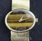 A lady's 1960's DeLaneau 18ct gold manual wind dress wrist watch, with blind oval tiger's eye quartz