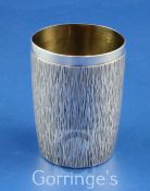 An early 1970's silver cylindrical beaker by Gerald Benney, with continuous bark effect decoration