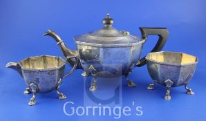 A 1930's three piece silver tea set by Mappin & Webb, of octagonal form, with scroll legs and pad