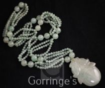 A multi bead jadeite drop pendant necklace, the pendant carved in the form of a peach, 34in.