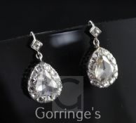 A pair of early Victorian pear shaped diamond drop earrings, set with central pear shaped rose cut