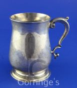 A George II silver baluster mug, with leaf capped scroll handle, maker's mark rubbed, London,