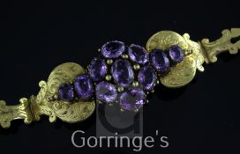 A Victorian pinchbeck and amethyst cluster bracelet, with engraved scrolling decoration and set with