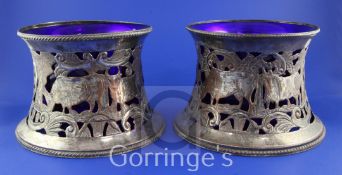 A near pair of 19th century pierced silver plated dish rings with blue glass liners, with engraved