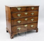 A George II walnut chest, of two short and three graduated long drawers, pine sides, on bracket