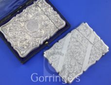 An Edwardian silver card case, with engraved monogram and embossed with scrolling foliage,