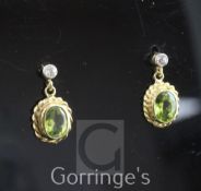 A pair of 18ct gold, peridot and diamond drop earrings, of oval form, with ropetwist gold border and