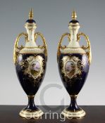 A pair of large Coalport oviform pedestal vases and covers, c.1902, painted with titled vignettes of