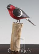 § Guy Taplin (1939-)painted wood,Bullfinch on a tree stump,signed and dated 2000,height 9in.